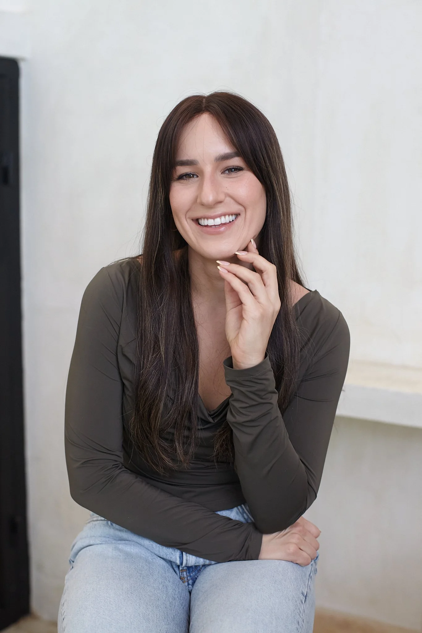 Mattie Chein, LCSW, seated and smiling in a long-sleeve top